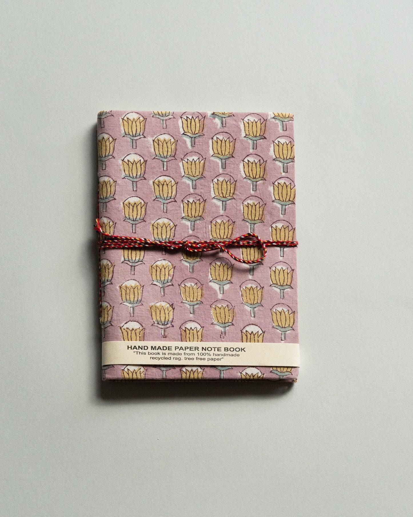 Handmade paper notebook with floral pattern on a gray background