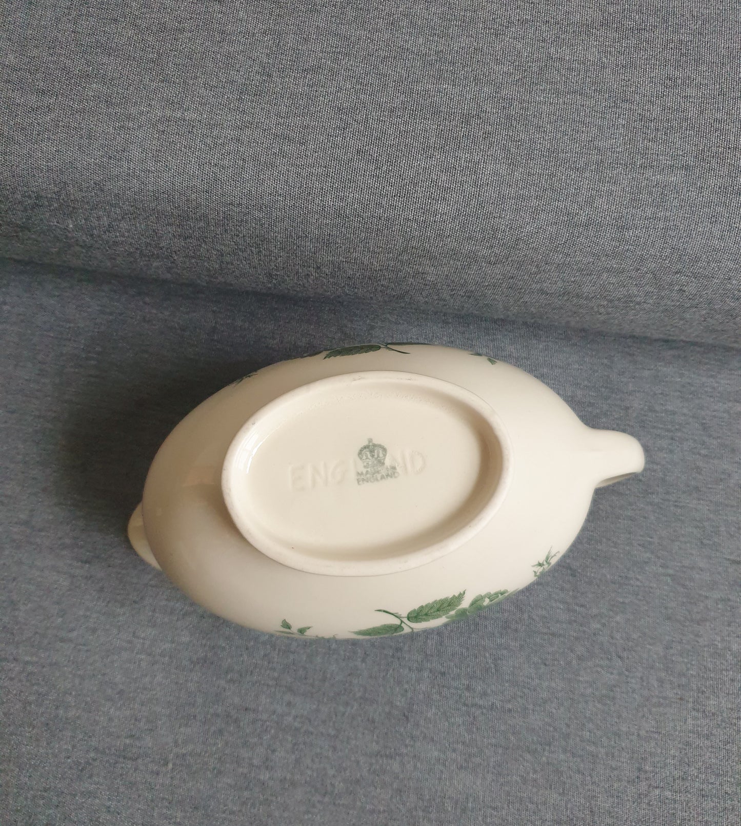 White ceramic dish with green patterns on a gray background