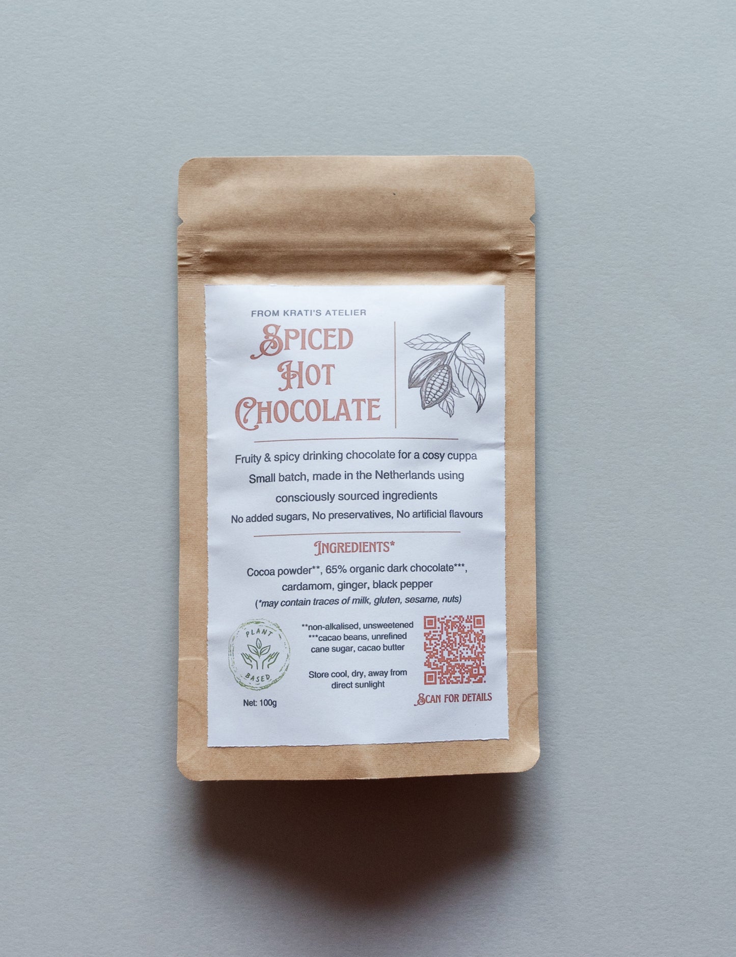 Spiced hot chocolate package with a label on a gray background