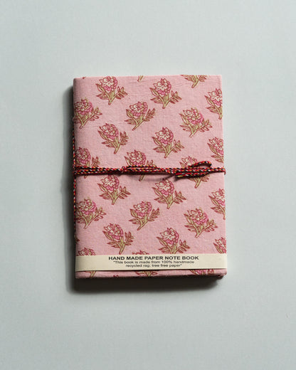 Handmade paper notebook with floral pattern on a light gray background