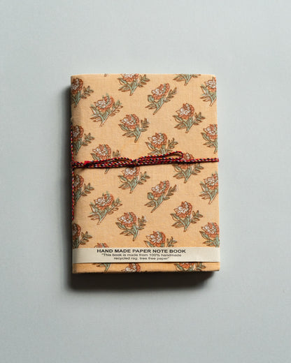 Handmade paper notebook with floral pattern on a gray background