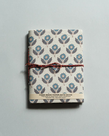 Handmade paper notebook with floral pattern on a gray background