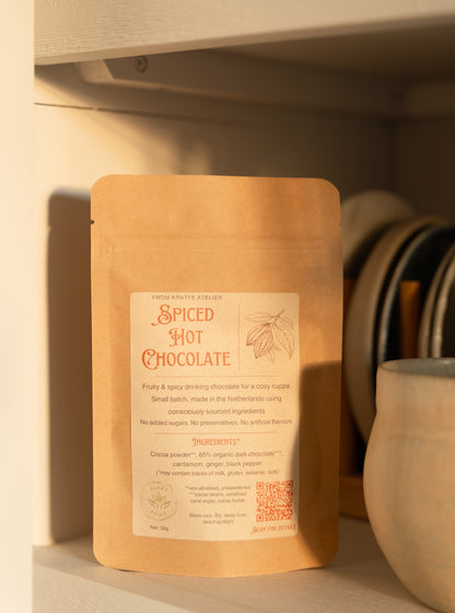 Spiced hot chocolate package on a shelf with a cup in the background